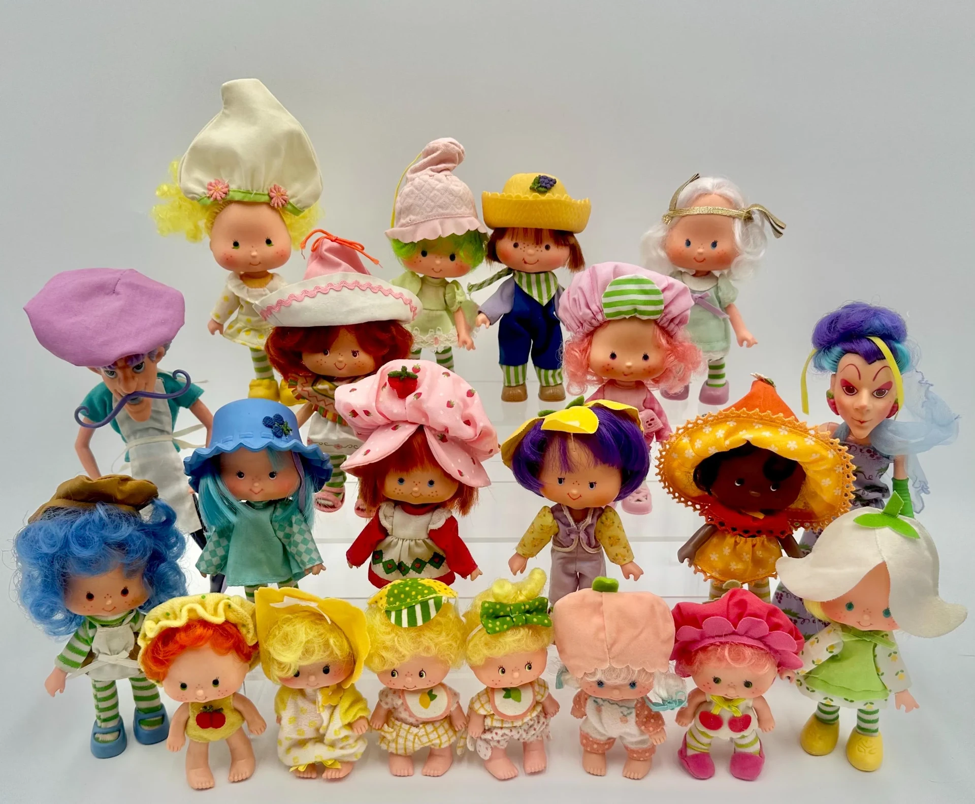 A collection of vintage Strawberry Shortcake dolls and friends